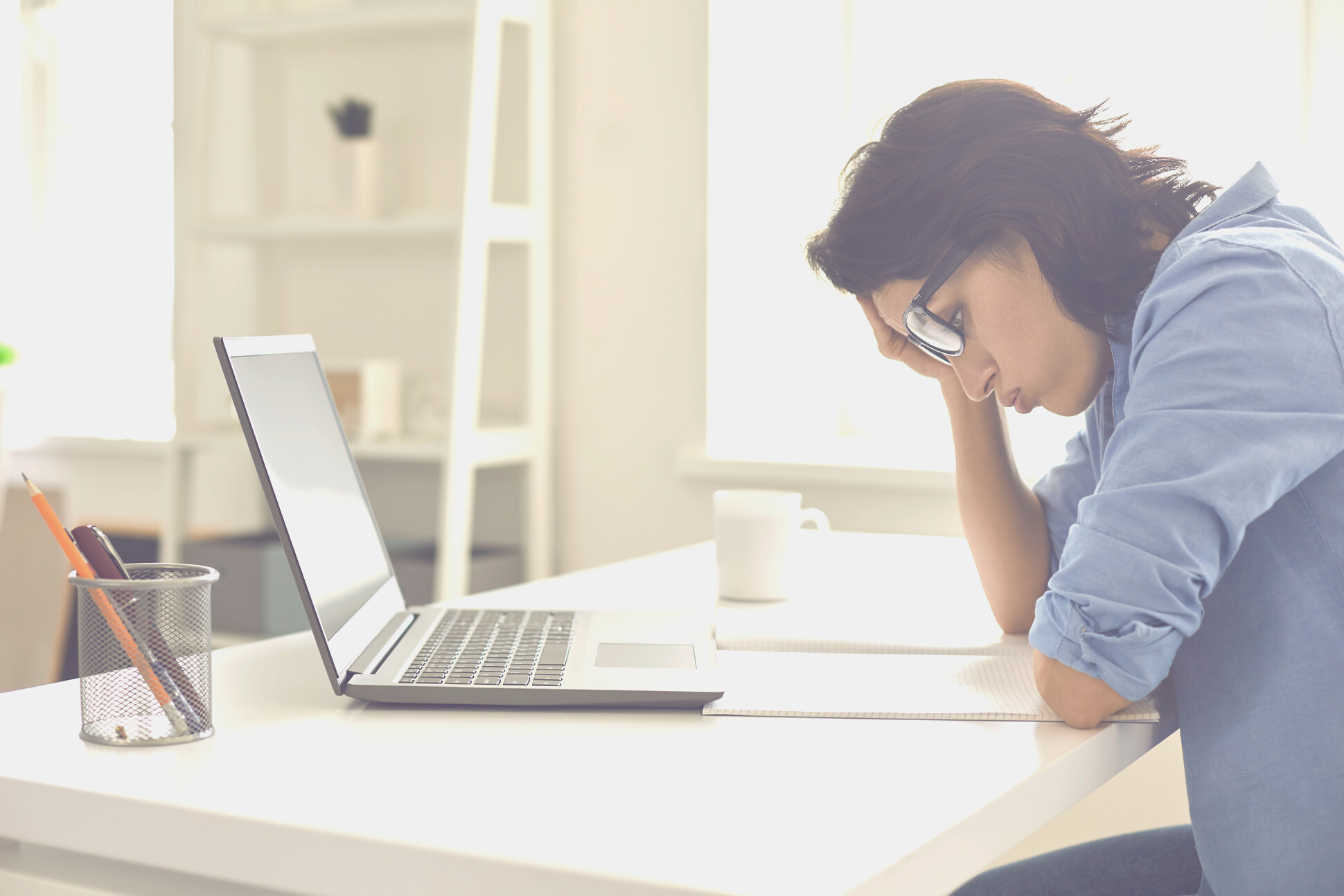 Exhausted Young Woman Working on Difficult Task in Front of Laptop at Home Office. Freelancer Feeling Tired at Workplace